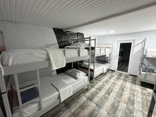 a dorm room with three bunk beds and a tile floor at STONE HOME Hostel in Istanbul