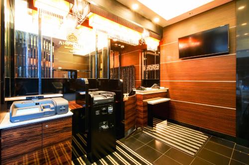 a restaurant with a counter with a computer on it at APA Hotel Tennoji Ekimae in Osaka