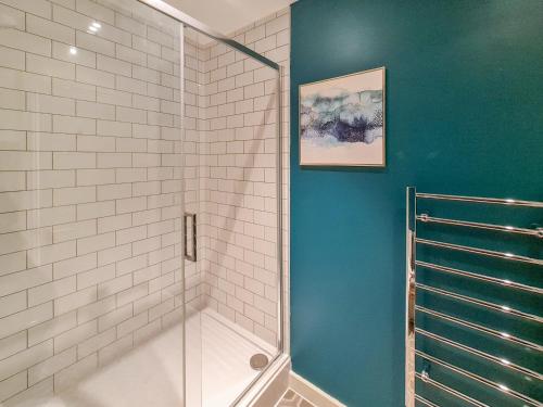 a shower with a glass door in a bathroom at The Post House Green in Gloucester