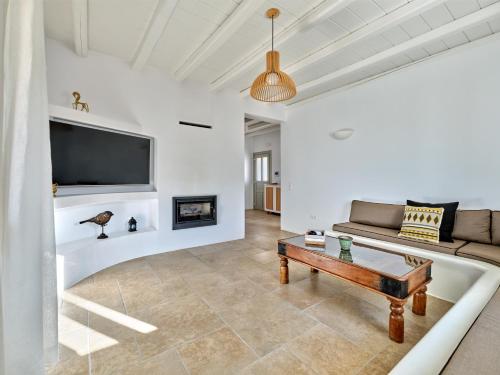 een woonkamer met een bank en een tafel bij Villa Leo - Unique & Calm in Kampos Paros
