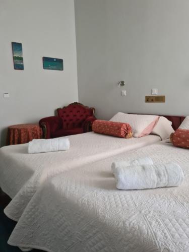 two beds sitting next to each other in a room at Greco Hotel in Hydra