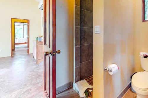 a bathroom with a toilet and a walk in shower at Morningstar Breeze Gold Standard Certified in Hopkins