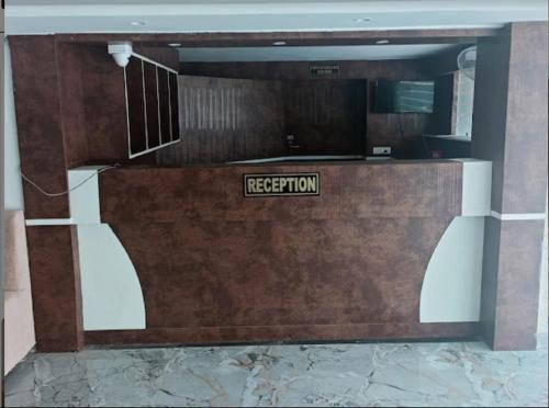 a reception desk with a sign that reads reception at Hotel Sakshi Inn Rooms and Restaurant in Gwalior