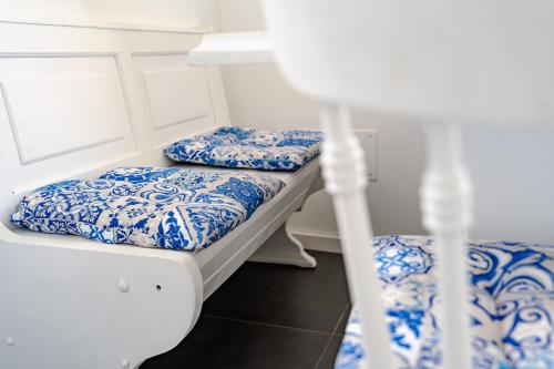 two bunk beds in a room with blue and white at Trieste 10min dal Centro Villa Privata con Jacuzzi in Trieste