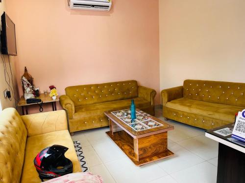 a living room with two couches and a table at Gopal Hotel and Palace in Jhunjhunūn