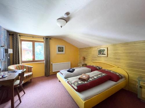 a bedroom with a bed and a table in it at Haus Gertraud in Oetz