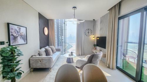 a living room with a couch and chairs at STAY BY LATINEM Luxury 2BR Holiday Home CV A2301 near Burj Khalifa in Dubai