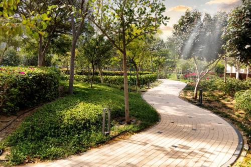 a walkway in a park with trees and flowers at STAY BY LATINEM Luxury 2BR Holiday Home CV A2301 near Burj Khalifa in Dubai