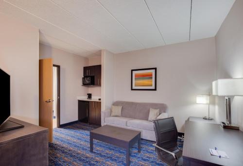 a living room with a couch and a table at Holiday Inn Express I-95 Capitol Beltway - Largo by IHG in Largo