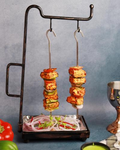two food items on a stand on a table at Stay Banaras - A Boutique Hotel in Varanasi