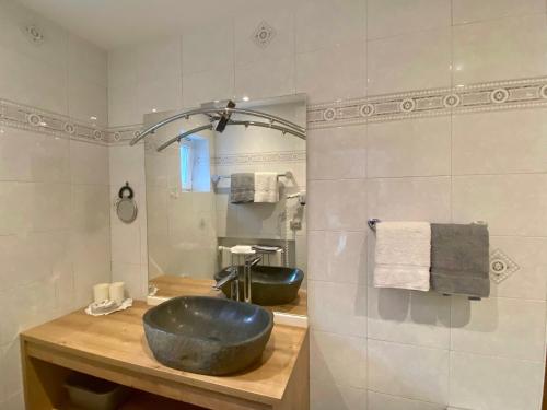 a bathroom with a large sink and a mirror at CESA VEDLA - Alpine Dolomites silent and cozy in Ortisei