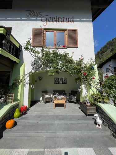 a building with a patio with a table in it at Haus Gertraud in Oetz