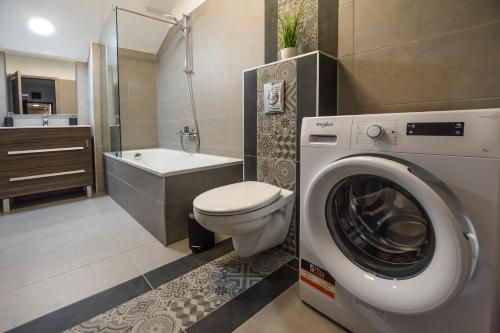 a bathroom with a washing machine and a toilet at K40 Boutique Apartment in the City Center in Budapest