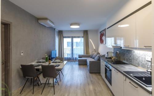 a kitchen and living room with a table and chairs at K40 Boutique Apartment in the City Center in Budapest