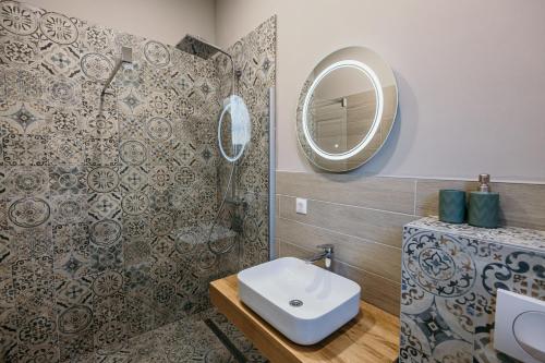a bathroom with a sink and a mirror at Pansion "Fawlty Towers" Sarajevo in Sarajevo