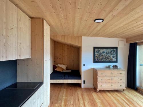 a room with a bed and a wooden ceiling at Schallerhof Sterzing - Deine Auszeit mit Ausblick in unseren Ferienwohnungen auf dem Bergbauernhof in Südtirol in Vipiteno