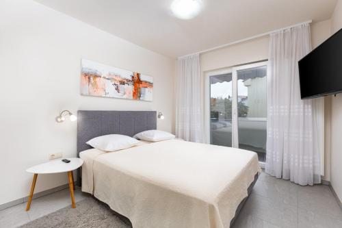 Postel nebo postele na pokoji v ubytování Apartments Pivas