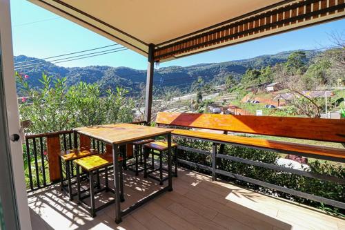 a table and chairs on a balcony with a view at ฟินอินดอย in Chom Thong
