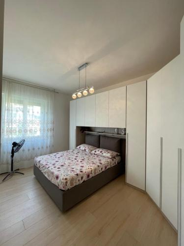 a bedroom with a large bed and white cabinets at Appartamento a 4 km dal Centro in Perugia