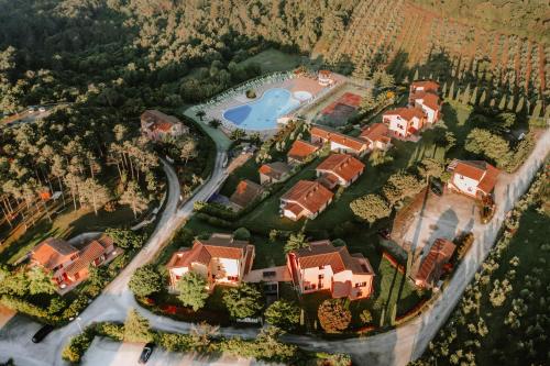 an aerial view of a house with a pool at Borgo San Pecoraio Resort in Riparbella