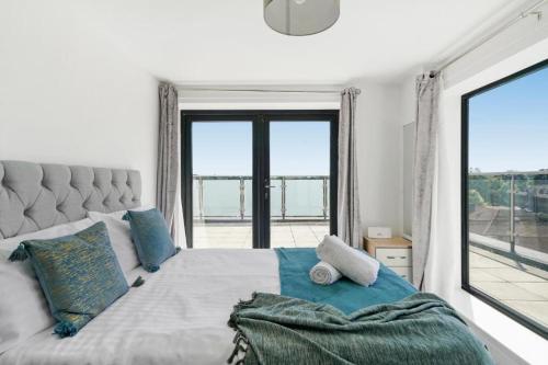 a bedroom with a bed with a large window at Heathrow Haven: Stylish Apartments in the Heart of Slough in Slough