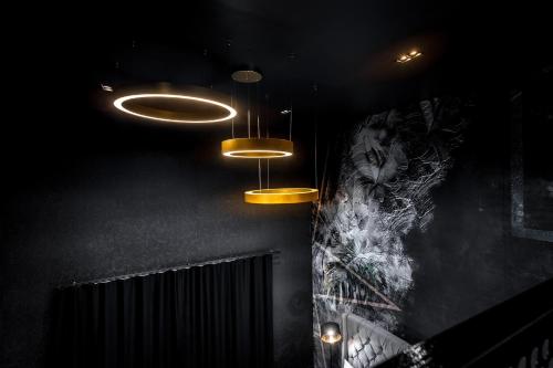 a room with lights hanging from the ceiling at Black Hotels Köln in Cologne
