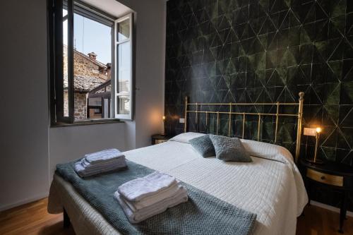 a bedroom with a bed with two towels on it at Cathedral House Orvieto in Orvieto