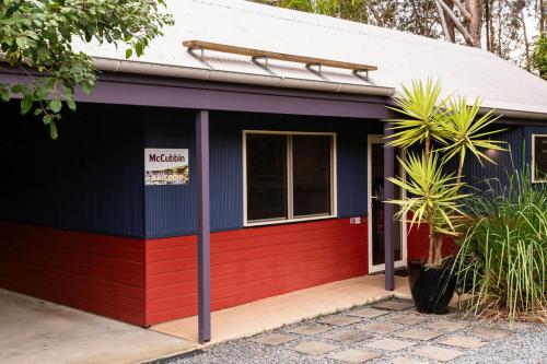 a red and blue building with a sign on it at Lake Russell Lakeside Retreat in Emerald Beach