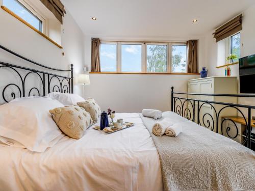 a bedroom with a large white bed with towels on it at The Ash Loft in Audlem