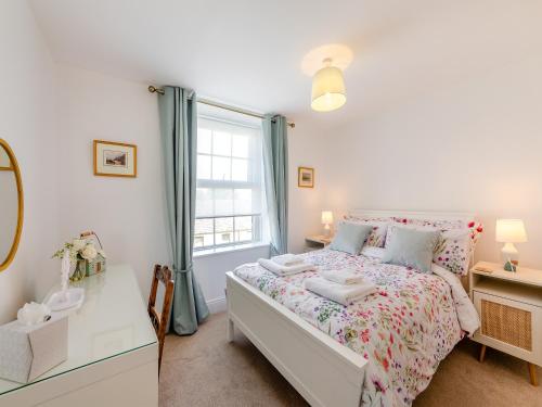 a small bedroom with a bed and a window at Hillcroft in Alnwick