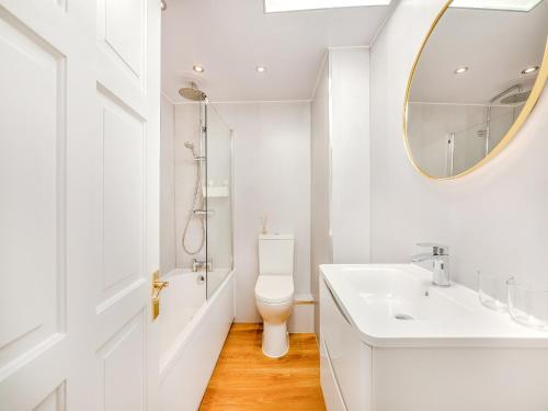 a white bathroom with a sink and a mirror at Hillcroft in Alnwick