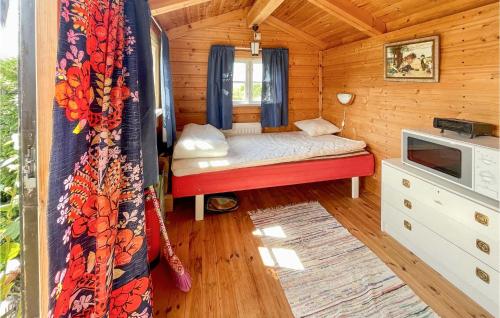 a small bedroom with a bed in a wooden cabin at 2 Bedroom Cozy Home In Degerhamn in Degerhamn