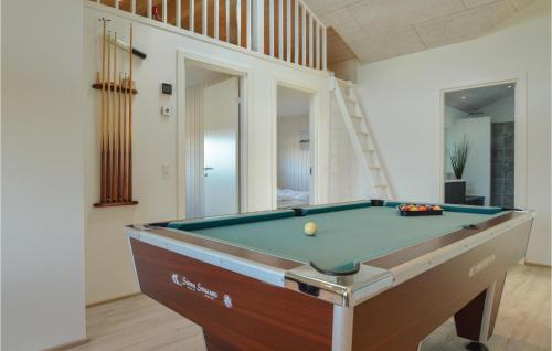 a pool table in a room with a staircase at Four-Bedroom Holiday Home In Hadsund in Haslevgårde