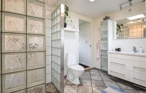uma casa de banho com um WC e um lavatório em 3 Bedroom Cozy Home In Juelsminde em Sønderby