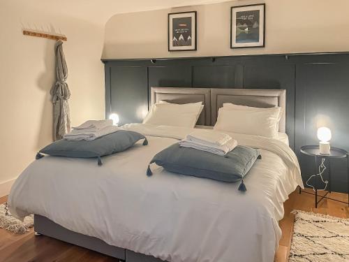a bedroom with a large bed with two pillows on it at Fonseca Cottage in Aberfeldy