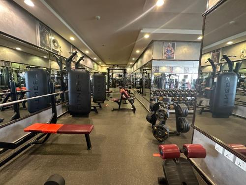 a man in a gym with several rows of equipment at Makarim Palm Hotel in Rabigh