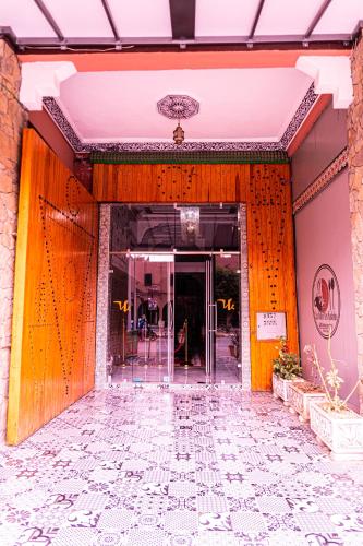 an entrance to a building with orange walls at HOTEL LA VALLEE DES KASBAHS CHEZ ILYAS in Tinerhir