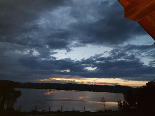 a view of a lake under a cloudy sky at Prenočišče ČERNOŠA Apartma Studio in Gradišče v Slovenskih Goricah