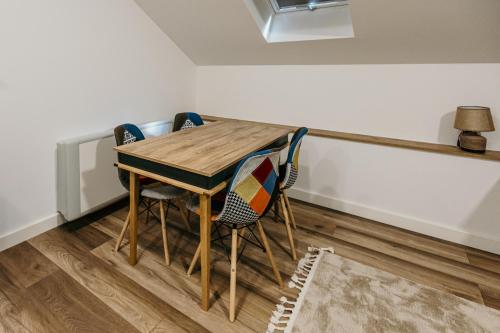 a wooden table and chairs in a room at Pansion "Fawlty Towers" Sarajevo in Sarajevo