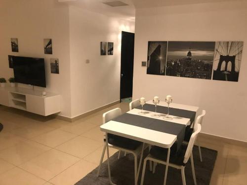 a dining room with a black and white table and chairs at Modern two bedroom appartment in Amman