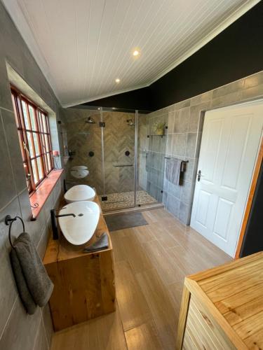 a bathroom with a sink and a shower at OAK HOUSE, Entire holiday home, Self catering, fully equipped, double storey, 3 bedroom, 2 bathroom, outside entertainment, Braai area, 300sqm home in Hillcrest