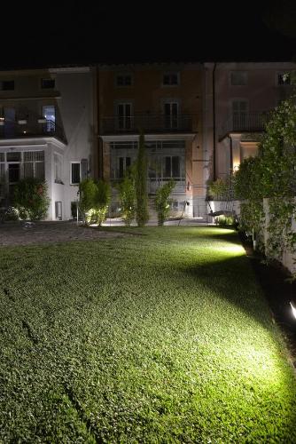 a large yard with a building at night at Residenza Cece' in Lecco