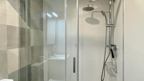 a shower with a glass door in a bathroom at Ribalta 1-1 in L'Escala