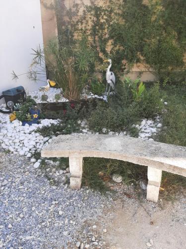 a stone bench with a statue of a goat on it at Chez Monique et Rémi in Avignon