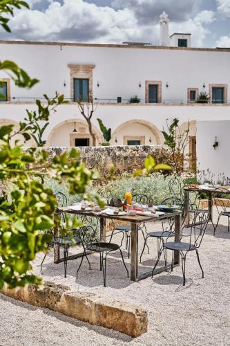 a group of tables and chairs in front of a building at Bambarone La Masseria in Fasano