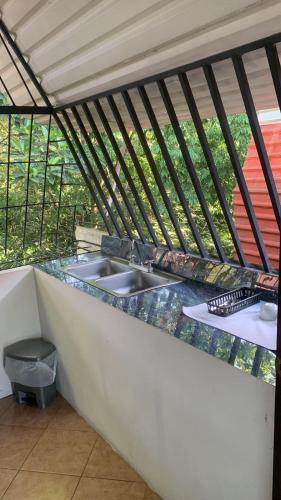 a kitchen counter with a sink in a house at Eco Hotel Villas del Tortuguero in Cariari