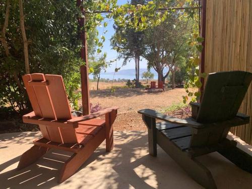 two chairs and a bench sitting on a porch at Bed & Bread in Chorazim