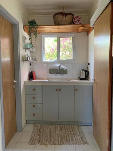 a kitchen with a sink and a window at Bed & Bread in Chorazim