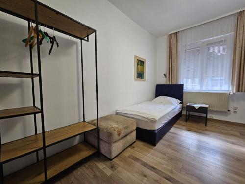 a bedroom with a bunk bed and a chair at Hotel Haus Isenburg in Neu Isenburg