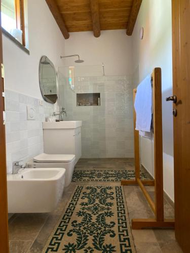 a bathroom with a toilet and a sink and a mirror at Vila Ramaj in Berat